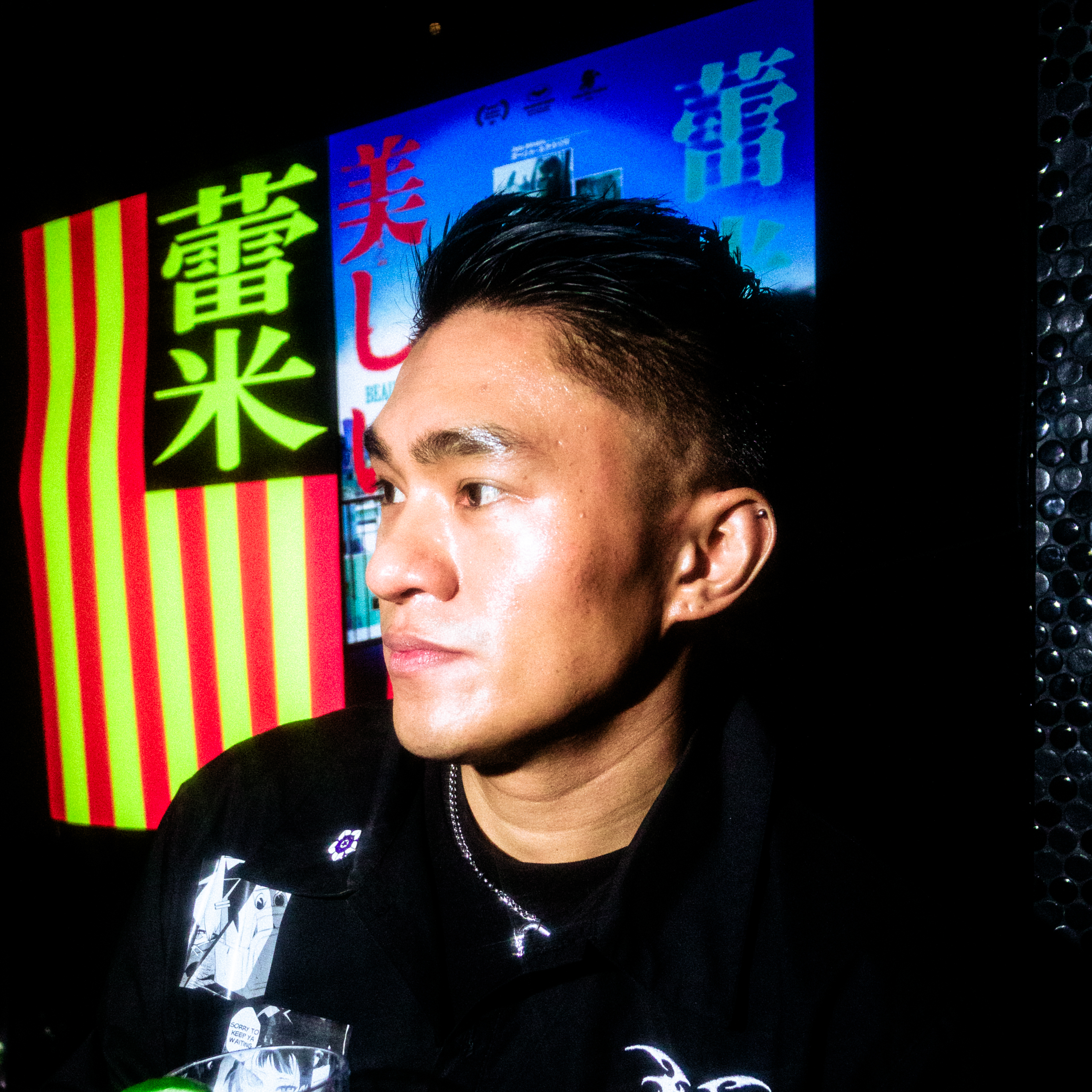 Christopher Davila profile portrait under Japanese neon